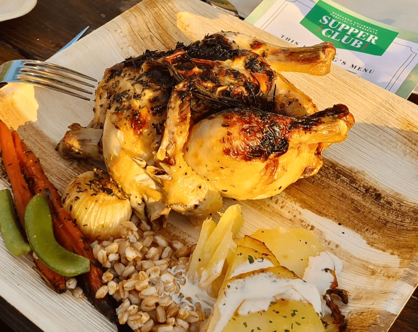 A roasted chicken and vegetables on a plate. 